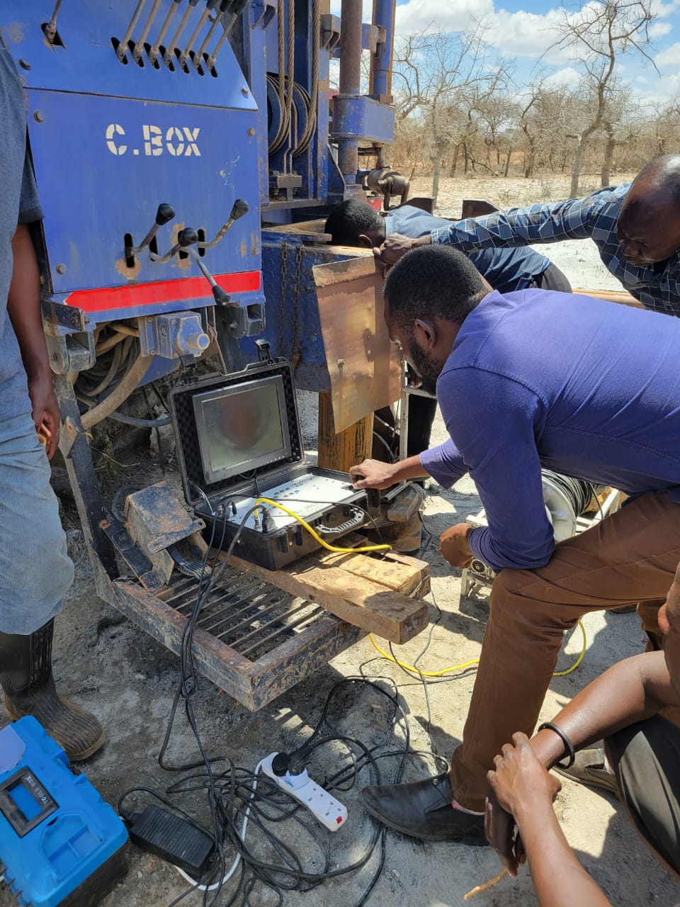 Hamiki team conducting a borehole camera inspection beside a drilling rig